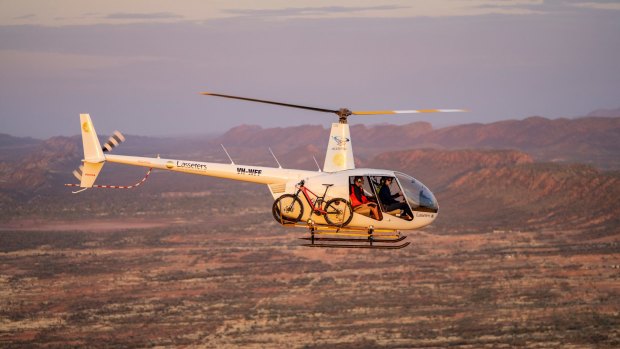 See the MacDonnell Ranges from the sky before hitting the bike trail.