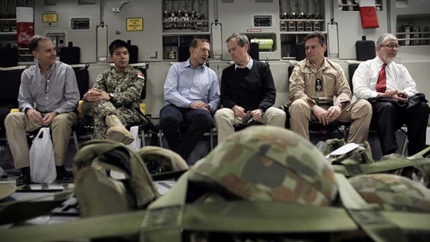 Bipartisan visit: Tony Abbott and Bill Shorten chat aboard the aircraft on their way to attend the ceremony in Tarin Kowt.