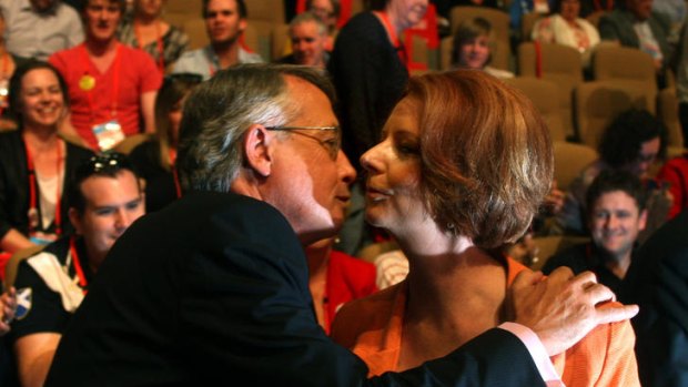 Treasurer Wayne Swan congratulates Julia Gillard after the sale of uranium to India was approved at the Labor Party national conference.
