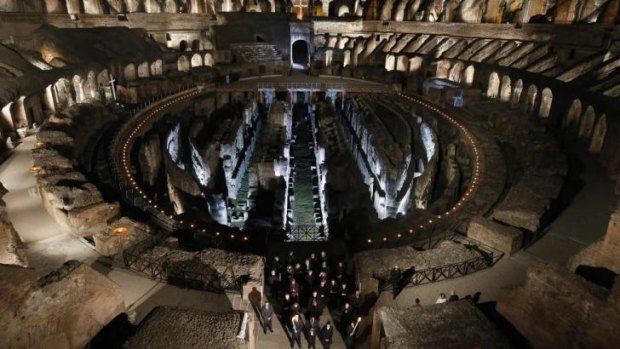 Pope Francis leads the Via Crucis procession at the Colosseum in Rome.