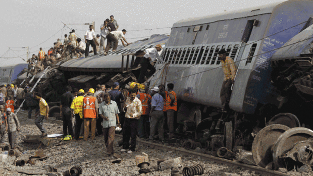 Indian rescue workers and security personnel search for survivors and victims at the site of a train crash near Sardiha, West Bengal state, India.