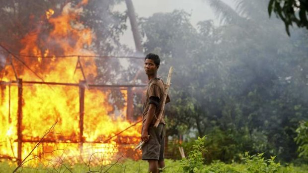 Burnt out: Rohingya homes are attacked in Arakan in June.