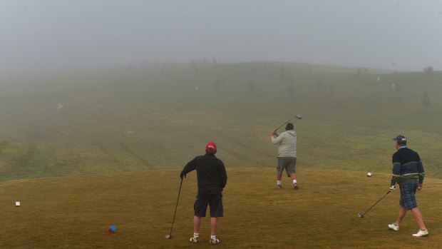 Hazy future: Players hit off in a winter fog on the Gardiners Run course at Lilydale.