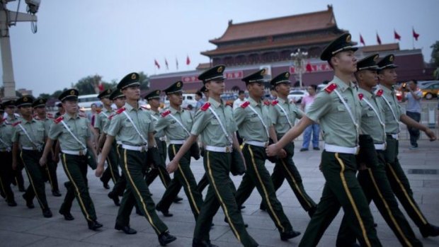 Paramilitary policemen march on Tiananmen Square after a flag-lowering ceremony in Beijing.