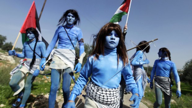 Protesters dress in Avatar style to draw attention to their campaign against the Israeli barrier.