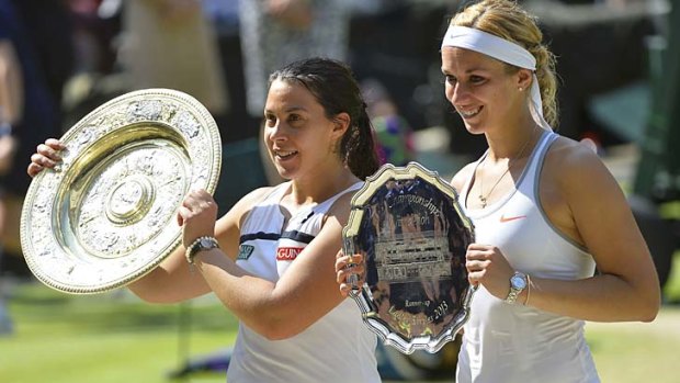 Winner Marion Bartoli of France and runner-up Sabine Lisicki of Germany hold their trophies after the women's singles final at Wimbledon on Saturday.