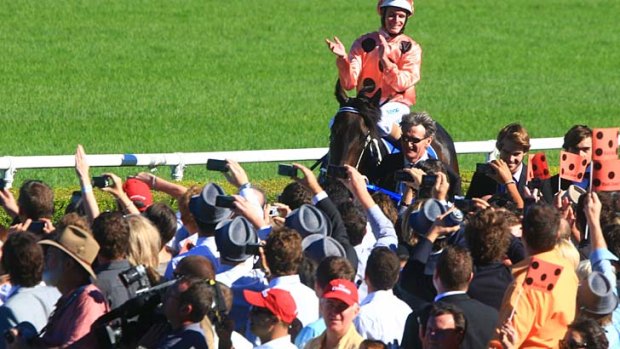 Been there, done that: Jockey Luke Nolen joins in the adulation of the crowd after Black Caviar won the 2011 running of the T.J. Smith Stakes at Randwick.
