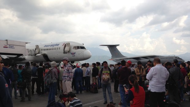 People are anxiously waiting at Kathmandu airport to catch a flight out of the quake-ravaged country.