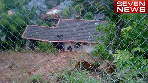 A mud slide at Rockhampton threatens homes.