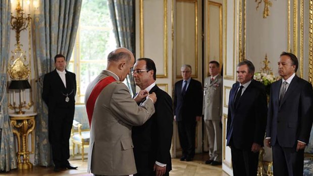 It's official ... Francois Hollande is awarded the Grand Maitre in the Order of the Legion of Honour as he is sworn in as President of France at the Elysee Palace yesterday.