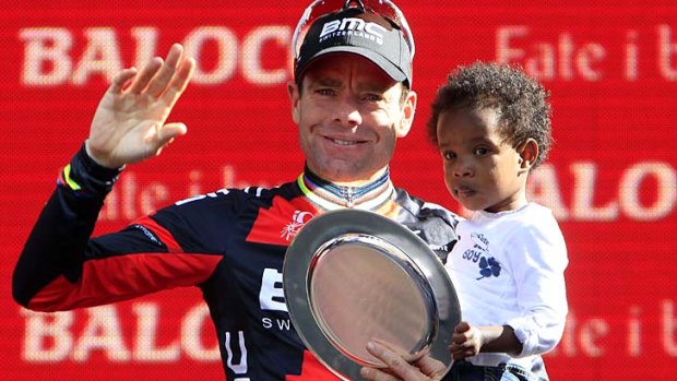 Cadel Evans holds his son Robel as he celebrates his podium finish in the Giro d'Italia.