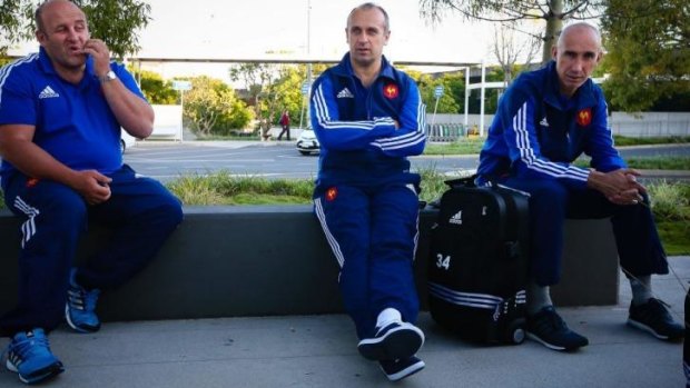 Philippe Saint-Andre (centre) relaxes outside Brisbane Airport this week.