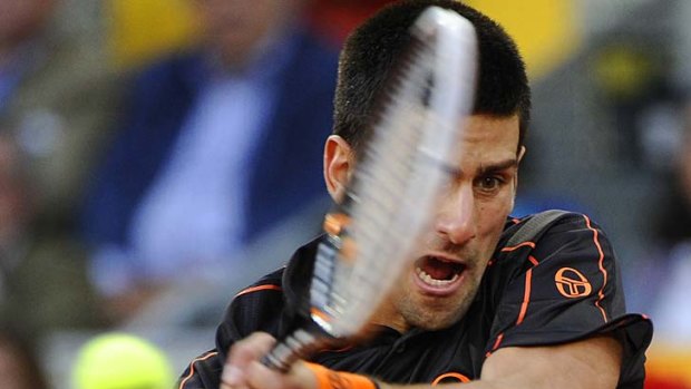 Winning streak ... Novak Djokovic returns a ball to Rafael Nadal.