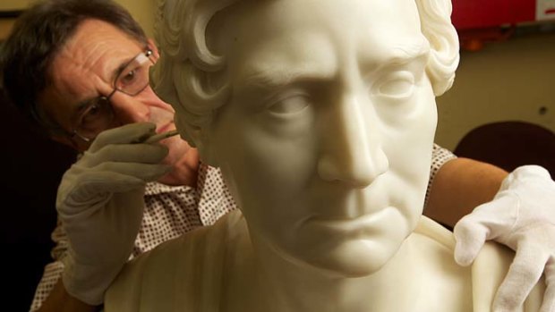 Restored ... a conservator works on a bust of William Wentworth, who 200 years ago found a way across the Blue Mountains.