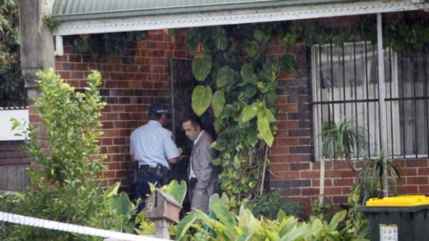 Police examine evidence at a house in Sydney where a toddler was found dead.