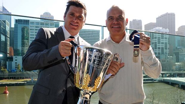 Premiership Cup ambassador Shane Crawford and Greg Williams with the Norm Smith Medal.