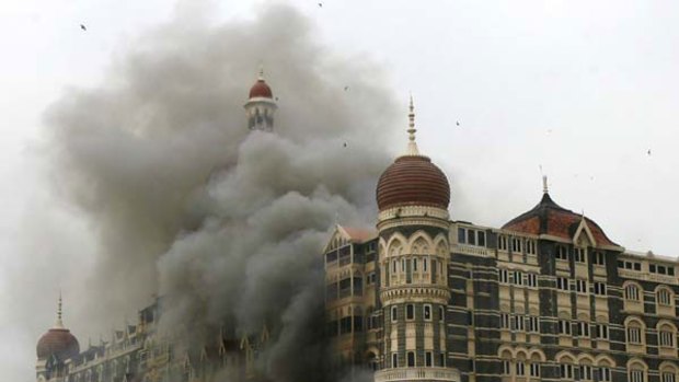The Taj Mahal hotel is seen engulfed in smoke during the gun battle in Mumbai on November 29, 2008.