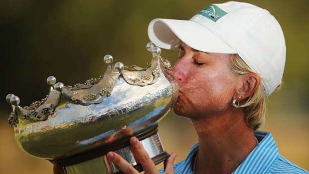 Karrie Webb kisses her trophy after coming from behind to win the Women's Australian Open.