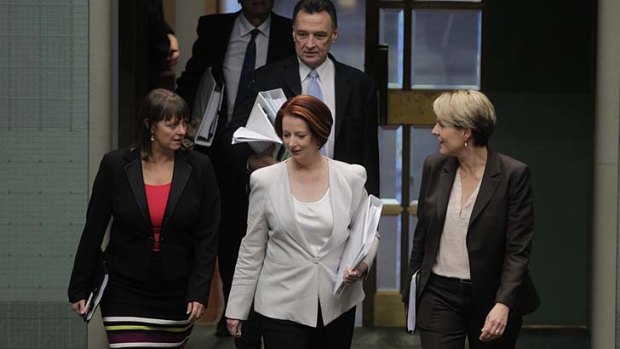 Prime Minister Julia Gillard enters the chamber for question time, with Labor colleagues Nicola Roxon and Tanya Plibersek.
