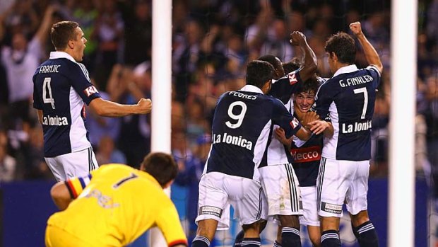 Celebrations: Melbourne Victory's Marco Rojas is congratulated by teammates after scoring against Adelaide.