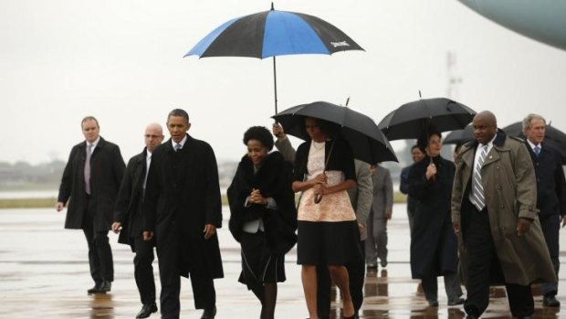 US President Barack Obama (3rd left) and first lady Michelle Obama (centre) arrive in Johannesburg.