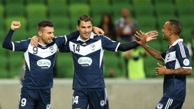 Victory's Kosta Barbarouses (left) celebrates his goal with James Troisi (centre) and Archie Thompson during the match against Yokohama F Marinos on Tuesday.