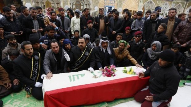 Mounting toll: Mourners pray over the coffin draped with an Iraqi flag of Iraqi soldier, Ali Alwan, who was killed during the clashes in Ramadi, during his funeral procession in the Shiite holy city of Najaf, south of Baghdad.