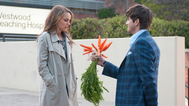 And what, exactly, am I supposed to do with these?: Natalie Portman receives a loving gesture of non-commitment from Ashton Kutcher in the adult-oriented rom-com No Strings Attached.