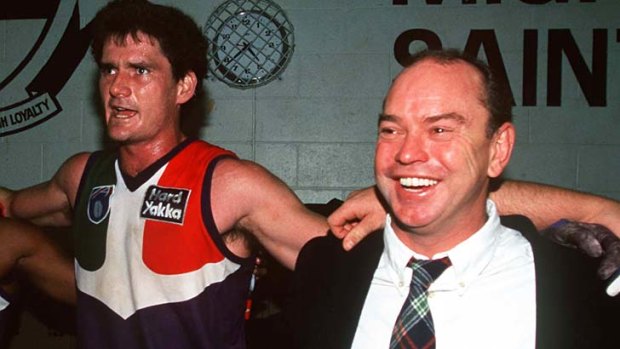 Coach Gerard Neesham and captain Peter Mann sing the club song after a win over Hawthorn in 1997.
