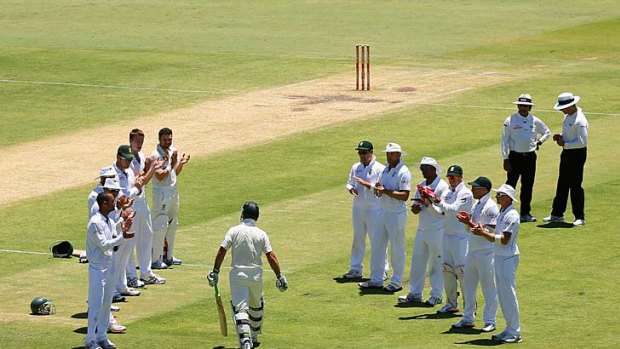 Final stand: South African players form a guard of honour as Ricky Ponting makes his final walk to the middle on Monday.