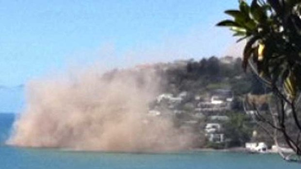 Dust rises from rocks were falling from a cliff in the Christchurch suburb of Sumner moments after an earthquake struck.