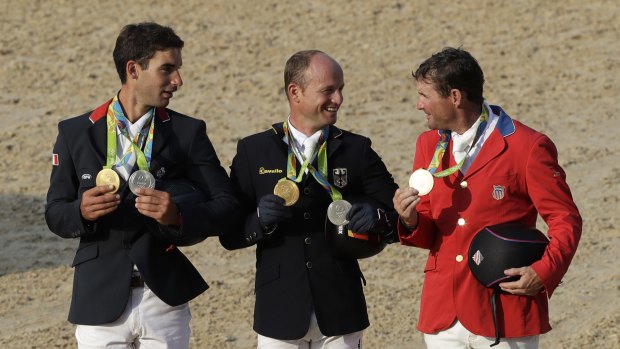 Podium trio: Michael Jung of Germany is flanked by silver medalist Astier Nicolas of France (left) and bronze medalist Phillip Dutton, of the United States.