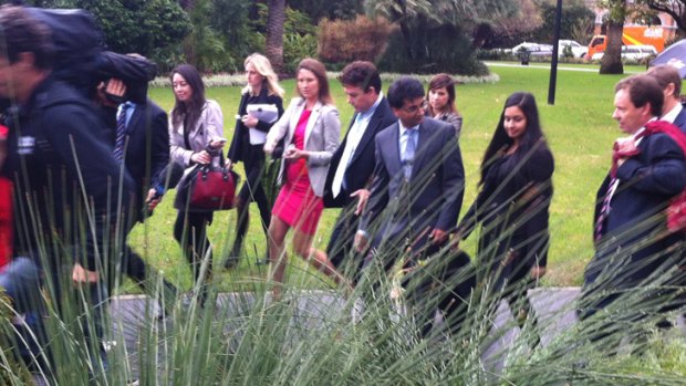 Lloyd Rayney is greeted by Perth's media as he heads back to court.