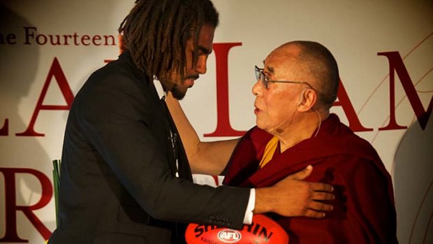 Harry O'Brien and the Dalai Lama share an embrace.