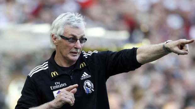 Magpies coach Mick Malthouse gives instructions from the bench towards the end of the third quarter.