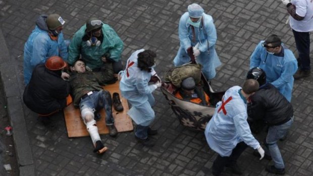 First aid workers attend to injured protesters in Independence Square on Thursday.