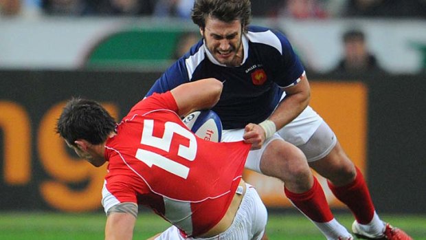 France's fullback Maxime Medard  fights for the ball with Wales full back Lee Byrne.