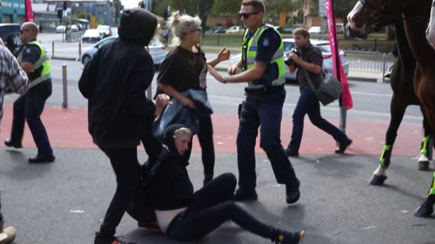 Police attempt to calm clashing protesters outside the Halal festival in Ascot Vale. 