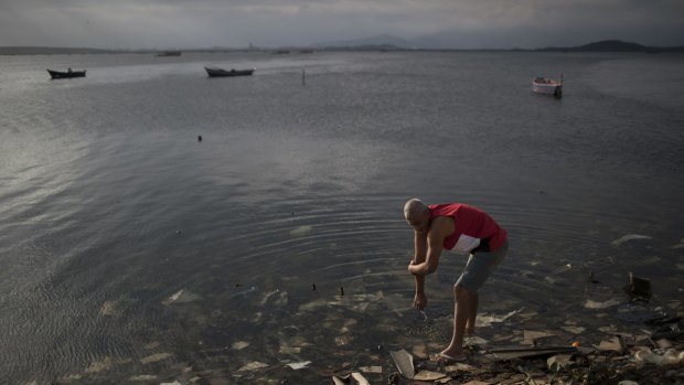 A man washes himself in the polluted waters of Guanabara Bay in the lead-up to the Rio Games.