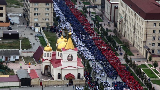 Honouring Putin ... In the Chechen capital of Grozny, thousands gathered to form a 600-metre long Russian flag through the streets. 