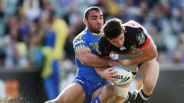 One to watch: Parramatta Eels captain Tim Mannah wraps up Warriors five-eighth Chad Townsend.