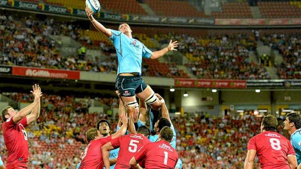 Kane Douglas of the Waratahs soars high in the lineout on Saturday against the Reds in Brisbane.