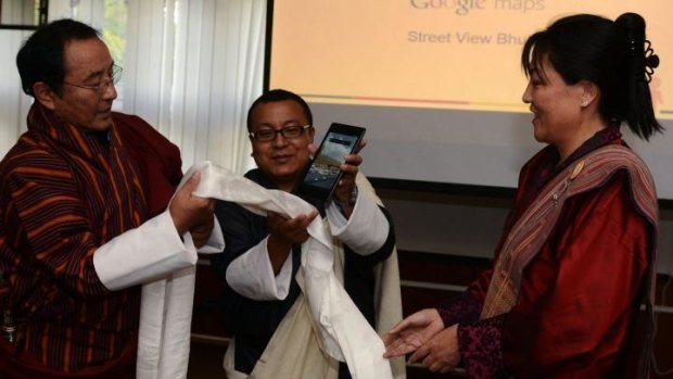 Bhutan Information and Communication secretary Dasho Kinley Dorji (left) and Director of the Bhutan Tourism Council Chhimmy Pen (right) perform a ritual during the launch of the Google Maps Street View project in Bhutan.