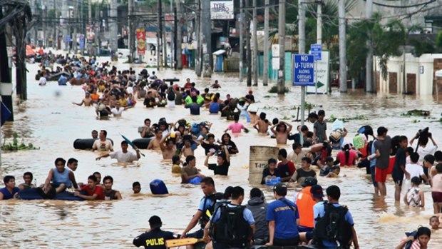 A flood of people east of Manila try to escape the disaster.