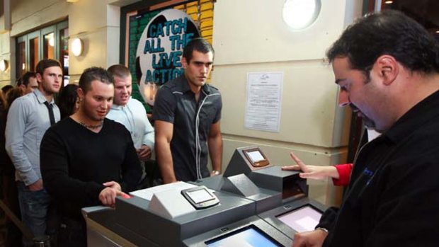 On trial... law-abiding patrons are ushered through the new security system at the Coogee Bay Hotel.