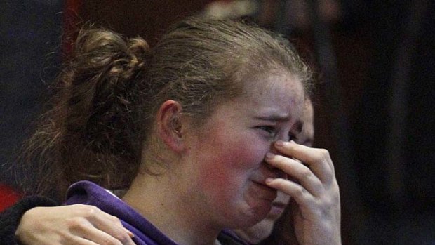 Alissa Sully, 17, cries during a prayer service for victims of the shooting.