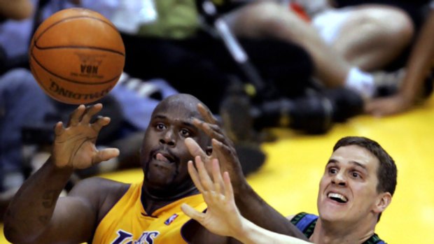 Pro basketballer Mar Madsen, right, takes on the Los Angeles Lakers' Shaquille O'Neal in 2004. Madsen reportedly bought the stolen domain name P2P.com from Daniel Goncalves.