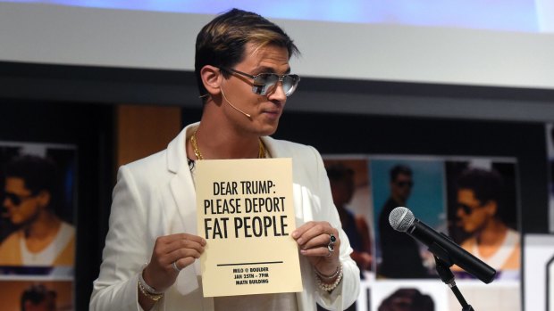 Milo Yiannopoulos holds a sign as he speaks at the University of Colorado campus in Boulder, Colorado. 