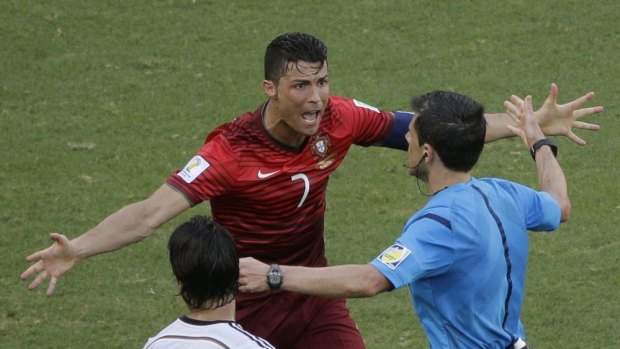 Drubbing ... Portugal's Cristiano Ronaldo protests to referee Milorad Mazic from Serbia during the 4-0 loss to Germany in group G.