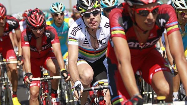 World champion Cadel Evans of Australia grimaces as he rides in the peloton.